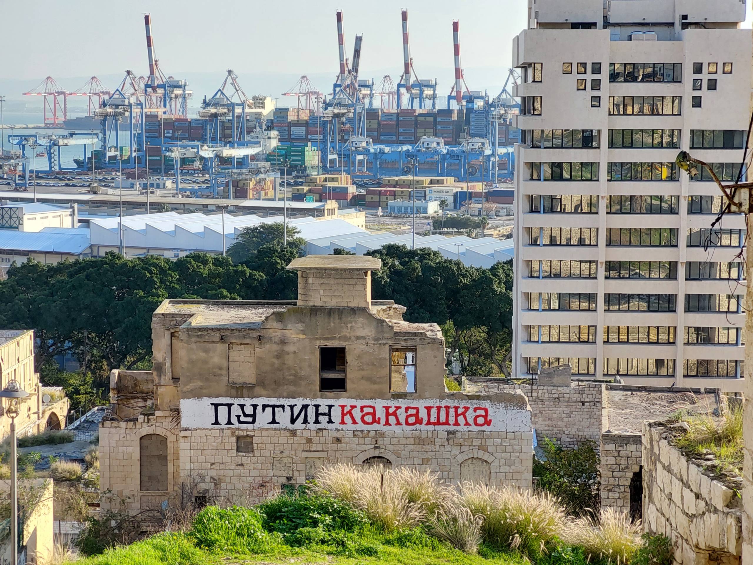 The sign on the wall of dilapidated building in Haifa says "Putin is shit"